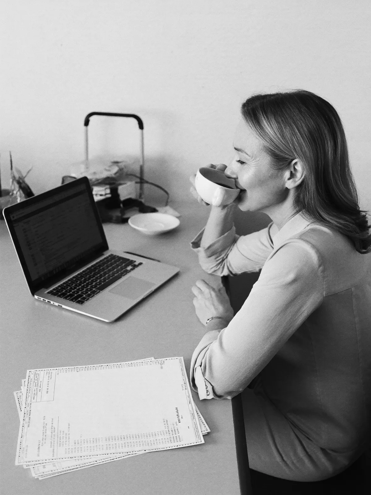 A restaurant owner relaxing with a coffee in her office after service