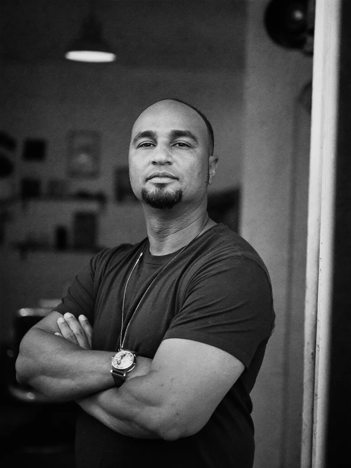 A barber standing in the doorway of his shop at opening time