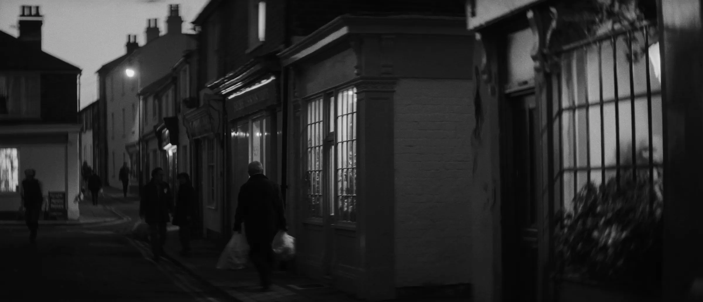 A seaside high street of independent shops at dusk